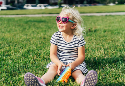 Full length of a girl sitting on field