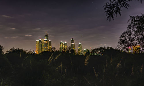 Panoramic view of city against sky at night