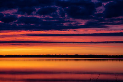 Scenic view of lake against romantic sky at sunset