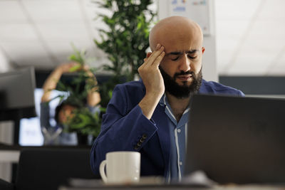 Young man using laptop at table