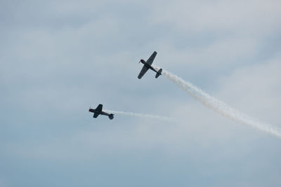 Low angle view of airshow against sky