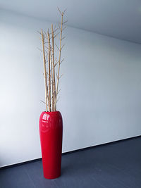 Close-up of vase on table against wall