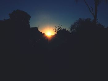 Silhouette trees against sky during sunset