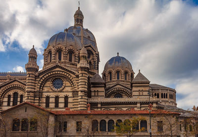 Low angle view of cathedral against cloudy sky