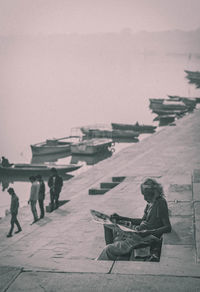 High angle view of man reading newspaper on steps