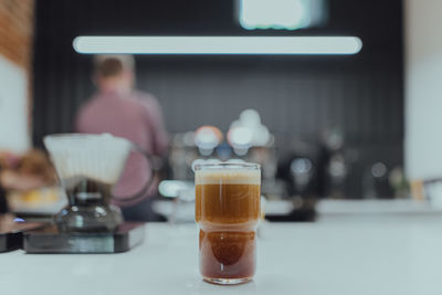 Close-up of nitro cold brew coffee in  glass on table