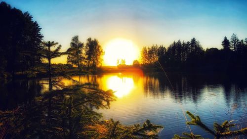 Scenic view of lake against sky during sunset