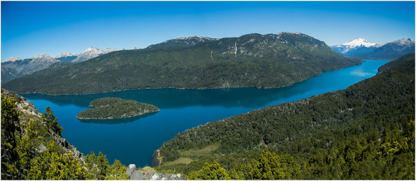 Scenic view of mountains against blue sky