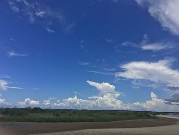 Scenic view of landscape against blue sky