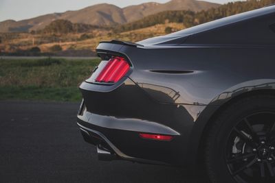 Close-up of car on road