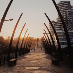 People walking on footpath at sunset