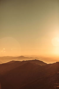 Scenic view of mountains against clear sky during sunset