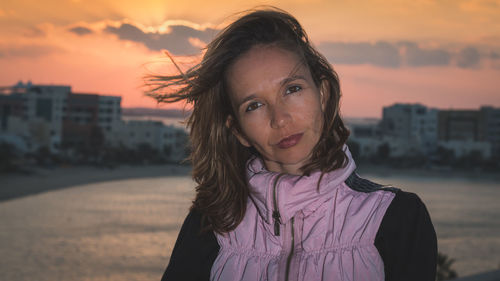Portrait of woman standing against sky during sunset