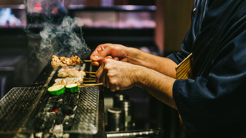 Close-up of man preparing food