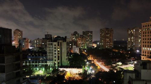 Illuminated cityscape against sky at night