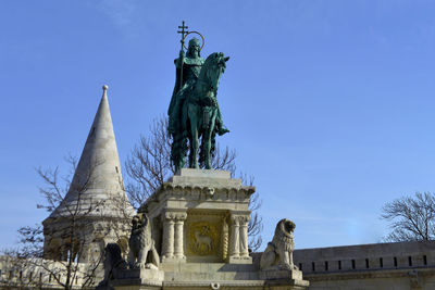 Low angle view of statue against blue sky