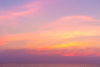 Scenic view of sea against romantic sky at sunset