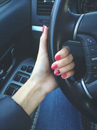 Cropped image of woman driving car