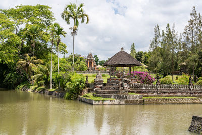 Built structure in lake against cloudy sky