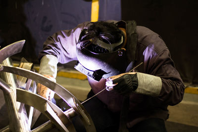 Man welding metal at factory