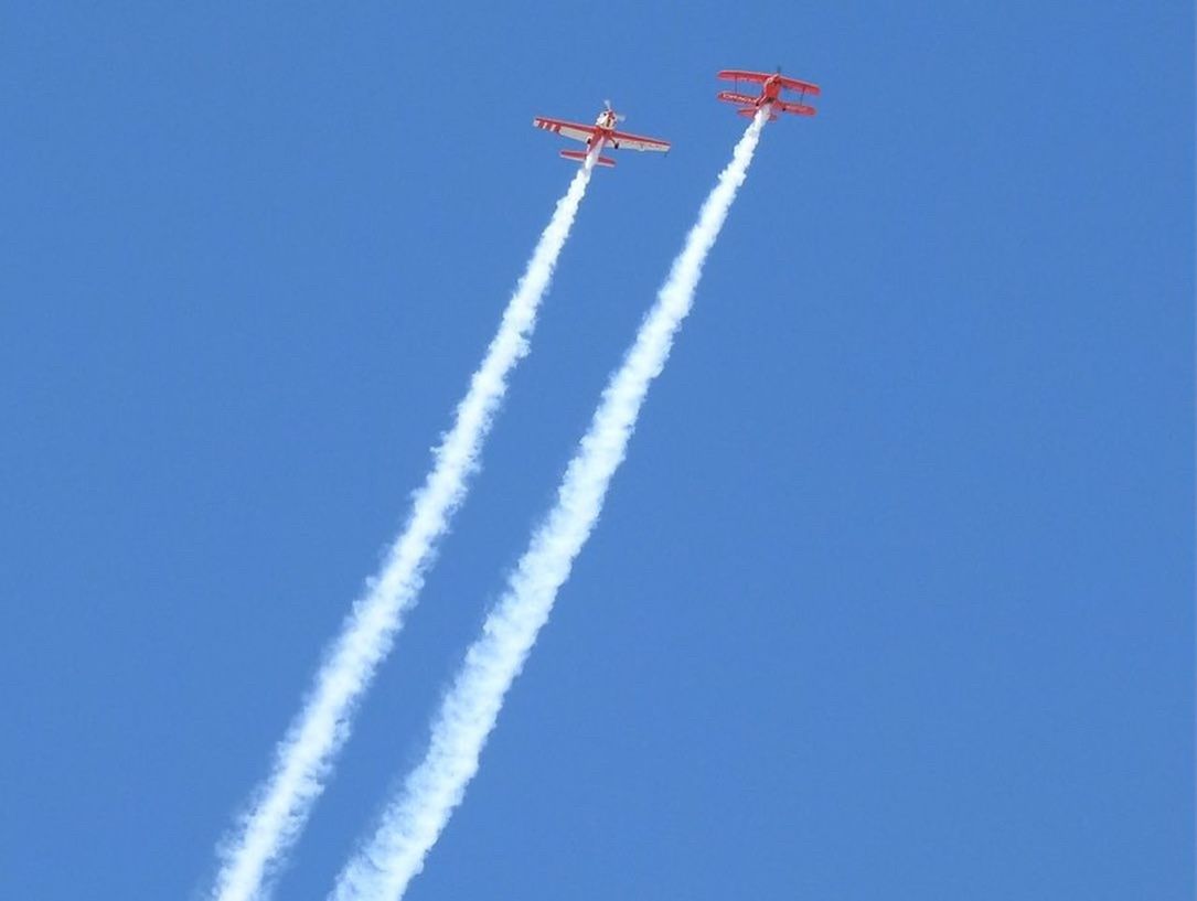 LOW ANGLE VIEW OF AIRSHOW AGAINST SKY