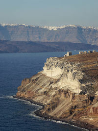 Scenic view of sea and mountains against clear sky