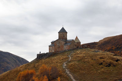 Colorful autumn landscape with gergeti trinity church on in the caucasus mountains, georgia.