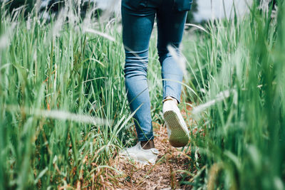 Low section of man standing on field