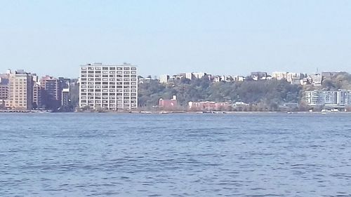 View of calm sea with cityscape in background