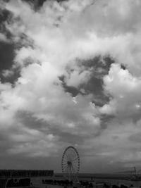 Ferris wheel against cloudy sky