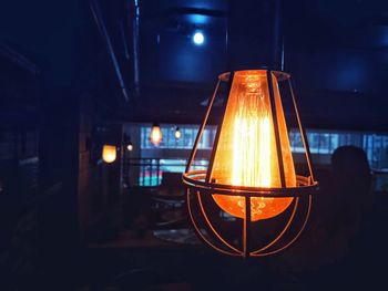 Close-up of illuminated light bulb in darkroom