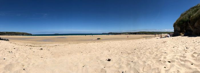 Scenic view of beach against clear blue sky