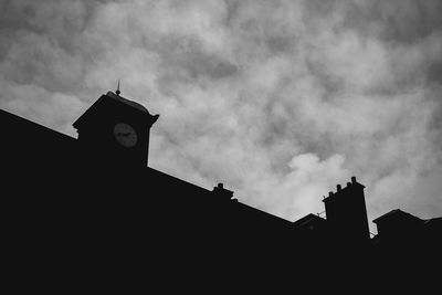 Low angle view of silhouette statue against sky