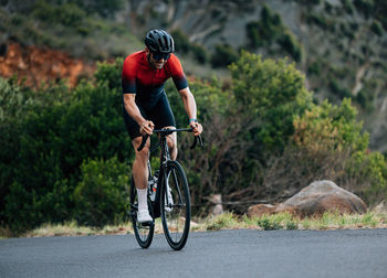 Man riding bicycle on road