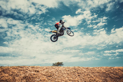 Motocross racer jumping high