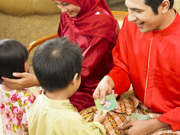 Family holding hands at home during celebration