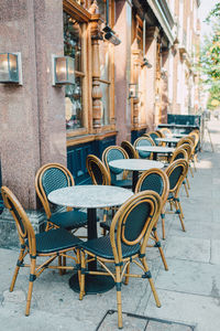 Sidewalk cafe by street in city