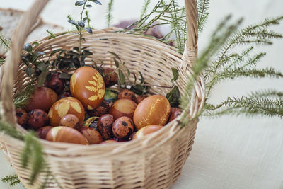 High angle view of easter eggs in wicker basket on table