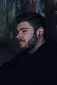 Close-up of thoughtful man looking away outdoors