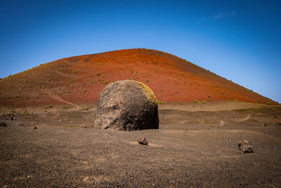 Built structure on land against clear blue sky