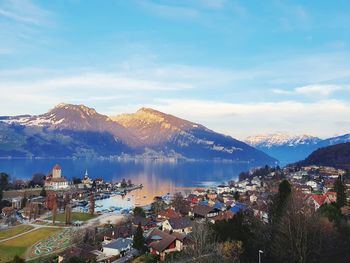 Panoramic shot of townscape by lake against sky