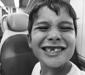 Portrait of smiling boy with gap tooth in vehicle
