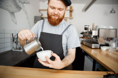 Man working with coffee cup in cafe