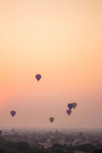 Hot air balloons flying in sky during sunset