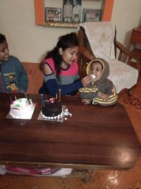 High angle view of people sitting on table at home