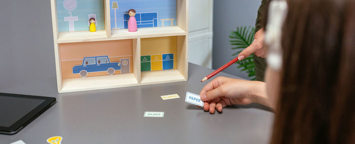 Cropped hands of woman using laptop on table