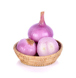 Close-up of fruits in basket against white background