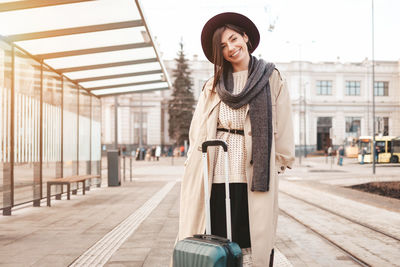 Portrait of a smiling young woman standing outdoors