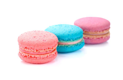 Close-up of multi colored candies against white background