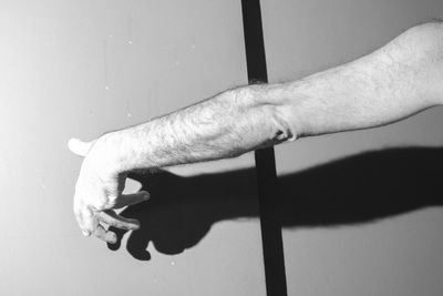 Cropped image of man standing against wall